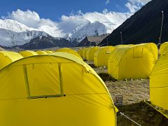 01B Tents line in a row at Ak-Sai Travel Lenin Peak Base Camp with Lenin Peak towering ahead